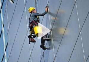 Man Cleaning Glass Building