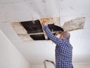 Man repairing collapsed ceiling