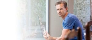 Man Cleaning Glass Window