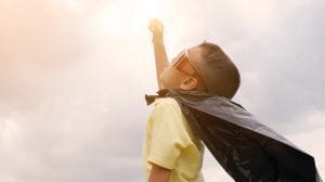 Child Wearing Sunglasses and Plastic Cape