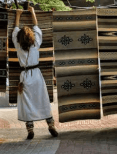 woman hanging rug to dry