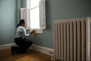 Woman cleaning in the mirror