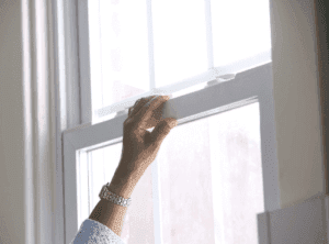 hand holding window
