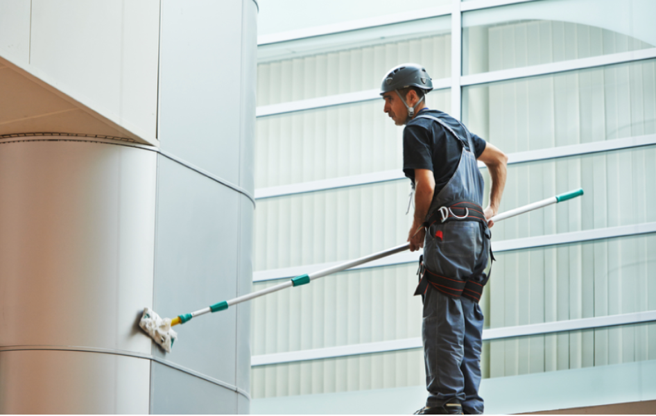 a man wearing a helmet and holding a mop