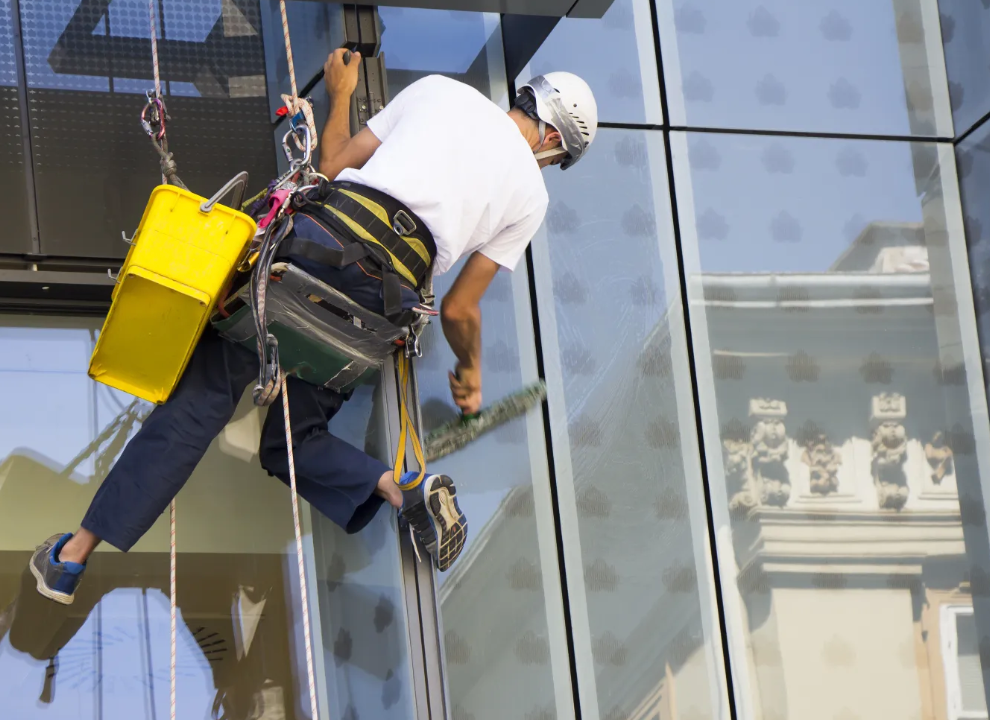 a man climbing a window