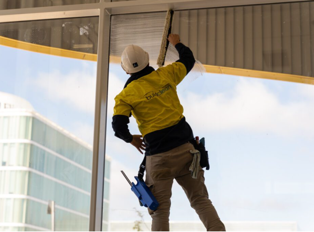 a man in a hard hat and yellow jacket